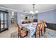 Open-concept dining room with views into kitchen and living spaces, set with a floral tablecloth at 3957 Tarpon Pointe Cir, Palm Harbor, FL 34684