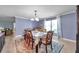 Bright dining room featuring colorful area rug, table with seating for six, and natural light at 3957 Tarpon Pointe Cir, Palm Harbor, FL 34684