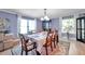 Charming dining room with large windows, decorative rug, and a table set for six at 3957 Tarpon Pointe Cir, Palm Harbor, FL 34684