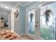 Bright entryway featuring decorative glass doors, and a view of a nicely decorated interior at 3957 Tarpon Pointe Cir, Palm Harbor, FL 34684