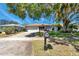 Charming single-story home with a well-manicured lawn and mature shade trees in a quiet neighborhood at 3957 Tarpon Pointe Cir, Palm Harbor, FL 34684