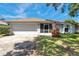 Inviting home with a well-kept lawn, a two car garage and a screened in porch enhancing curb appeal at 3957 Tarpon Pointe Cir, Palm Harbor, FL 34684