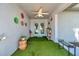Cozy front porch with artificial grass flooring, creating a welcoming and decorative entryway at 3957 Tarpon Pointe Cir, Palm Harbor, FL 34684
