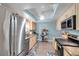 Modern kitchen with stainless steel appliances, light wood cabinets, and granite countertops at 3957 Tarpon Pointe Cir, Palm Harbor, FL 34684