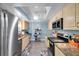 Well-lit kitchen with stainless steel appliances, granite countertops, and light wood cabinetry at 3957 Tarpon Pointe Cir, Palm Harbor, FL 34684