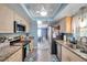 Well-lit kitchen featuring stainless steel appliances, light wood cabinets, and granite counters at 3957 Tarpon Pointe Cir, Palm Harbor, FL 34684