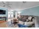 Comfortable living room showcasing a sectional sofa, ceiling fan, and access to the outdoor area at 3957 Tarpon Pointe Cir, Palm Harbor, FL 34684