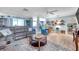 Inviting living room with a large sectional sofa, modern flooring, and stylish decor at 3957 Tarpon Pointe Cir, Palm Harbor, FL 34684