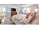 This main bedroom features a ceiling fan, closet and bright window; the en-suite bathroom is just steps away at 3957 Tarpon Pointe Cir, Palm Harbor, FL 34684