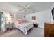 This main bedroom features a ceiling fan, artwork and floral theme creating a cozy and inviting atmosphere at 3957 Tarpon Pointe Cir, Palm Harbor, FL 34684