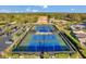 Aerial image of community tennis courts, surrounded by lush greenery and well-maintained facilities for recreational activities at 3957 Tarpon Pointe Cir, Palm Harbor, FL 34684