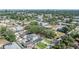 Aerial view showing neighborhood houses encircled by a dense canopy of trees and scattered with city buildings at 401 N Manhattan Ave, Tampa, FL 33609