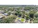An aerial view shows houses surrounded by many trees and glimpses of the city in the distance at 401 N Manhattan Ave, Tampa, FL 33609