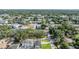 Wide aerial view of local homes amid leafy trees near an expansive road and cityscape at 401 N Manhattan Ave, Tampa, FL 33609