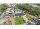 From an aerial perspective, view the home nestled in its green landscape, bordered by neighboring buildings at 401 N Manhattan Ave, Tampa, FL 33609