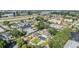 An aerial view of a neighborhood with modern homes, lush trees, and a highway in the background at 401 N Manhattan Ave, Tampa, FL 33609