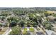 Expansive aerial shot highlighting neighborhood homes nestled among lush greenery and distant high-rise buildings at 401 N Manhattan Ave, Tampa, FL 33609