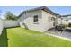 An inviting backyard features a well-manicured lawn, outdoor seating, and a patio perfect for entertaining or relaxing at 401 N Manhattan Ave, Tampa, FL 33609