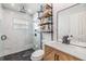 Bathroom with glass shower, rainfall shower head, and marble tile at 401 N Manhattan Ave, Tampa, FL 33609