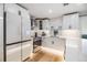Modern kitchen with white cabinets, stainless steel appliances, and stone countertops at 401 N Manhattan Ave, Tampa, FL 33609
