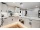 Bright kitchen featuring white cabinets, a subway tile backsplash, and stainless steel microwave at 401 N Manhattan Ave, Tampa, FL 33609