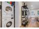 Laundry room with stacked washer/dryer and modern shelving with decorations at 401 N Manhattan Ave, Tampa, FL 33609
