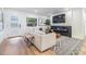 Cozy living room featuring a modern fireplace, mounted TV, and comfortable seating at 401 N Manhattan Ave, Tampa, FL 33609