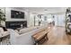 Spacious open-concept living space with a fireplace and a modern white kitchen at 401 N Manhattan Ave, Tampa, FL 33609