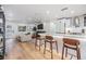 Open concept living space with a sleek kitchen, modern fireplace, and comfortable seating at 401 N Manhattan Ave, Tampa, FL 33609