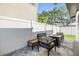 The outdoor patio has comfortable seating around a gas fire pit with a white fence on either side of the home at 401 N Manhattan Ave, Tampa, FL 33609