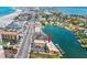Aerial view of apartment building with canal access, parking, and proximity to a major roadway at 4103 Gulf Blvd # 106, St Pete Beach, FL 33706