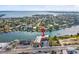 Aerial view of a yellow condo building near the water, featuring a serene coastal setting at 4103 Gulf Blvd # 106, St Pete Beach, FL 33706