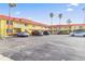 A multi-Gathering building with ample parking, palm trees, and a red tile roof at 4103 Gulf Blvd # 106, St Pete Beach, FL 33706