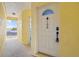 A close-up of the white front door of the residence, with a secure entry system at 4103 Gulf Blvd # 106, St Pete Beach, FL 33706