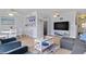Bright and airy living room with wood floors, stylish furniture, and a view of the water at 4103 Gulf Blvd # 106, St Pete Beach, FL 33706