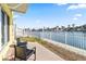 Inviting outdoor space with waterfront views, furnished with a comfortable seating arrangement at 4103 Gulf Blvd # 106, St Pete Beach, FL 33706