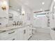 Updated bathroom with dual sink vanity, marble countertop, and decorative tile flooring at 4204 Saltwater Blvd, Tampa, FL 33615