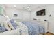 Bedroom features white walls, ceiling fan, a double door closet and a TV at 4204 Saltwater Blvd, Tampa, FL 33615