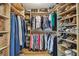 A walk-in closet provides generous storage space with custom wood shelving for clothes, shoes, and accessories at 4204 Saltwater Blvd, Tampa, FL 33615