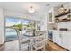 Inviting dining area with backyard pool access and a wine cooler built into the white cabinetry at 4204 Saltwater Blvd, Tampa, FL 33615