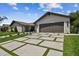 Beautiful home exterior featuring a modern garage, a paved driveway, and well-manicured landscaping enhances curb appeal at 4204 Saltwater Blvd, Tampa, FL 33615