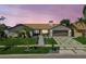 Charming single-story home featuring a manicured lawn, stone accents, and a modern driveway with integrated greenery at 4204 Saltwater Blvd, Tampa, FL 33615