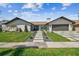 Inviting single-story home with stone details, a well-kept lawn, and a contemporary driveway with green accents at 4204 Saltwater Blvd, Tampa, FL 33615