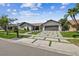Beautiful single-story home featuring stone accents, manicured landscaping, and a modern driveway with grass details at 4204 Saltwater Blvd, Tampa, FL 33615