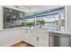 Bright kitchen with farmhouse sink, marble counters, stainless steel appliances, and a water view window at 4204 Saltwater Blvd, Tampa, FL 33615