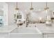 Bright kitchen with marble counters and island with lovely light fixtures at 4204 Saltwater Blvd, Tampa, FL 33615