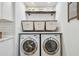 Bright laundry room features modern appliances, stylish storage baskets, and practical shelving at 4204 Saltwater Blvd, Tampa, FL 33615