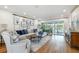 Spacious living room with sliding glass doors, hardwood floors, stylish furniture and backyard views at 4204 Saltwater Blvd, Tampa, FL 33615