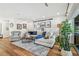 Cozy living room featuring hardwood floors, modern sofa, stylish decor, and comfortable seating at 4204 Saltwater Blvd, Tampa, FL 33615