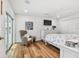 Bright main bedroom with hardwood flooring, large sliding door access, and a white dresser at 4204 Saltwater Blvd, Tampa, FL 33615